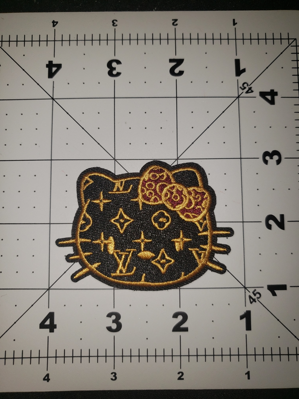 Black and Gold Hello Kitty Patch with Red Bow